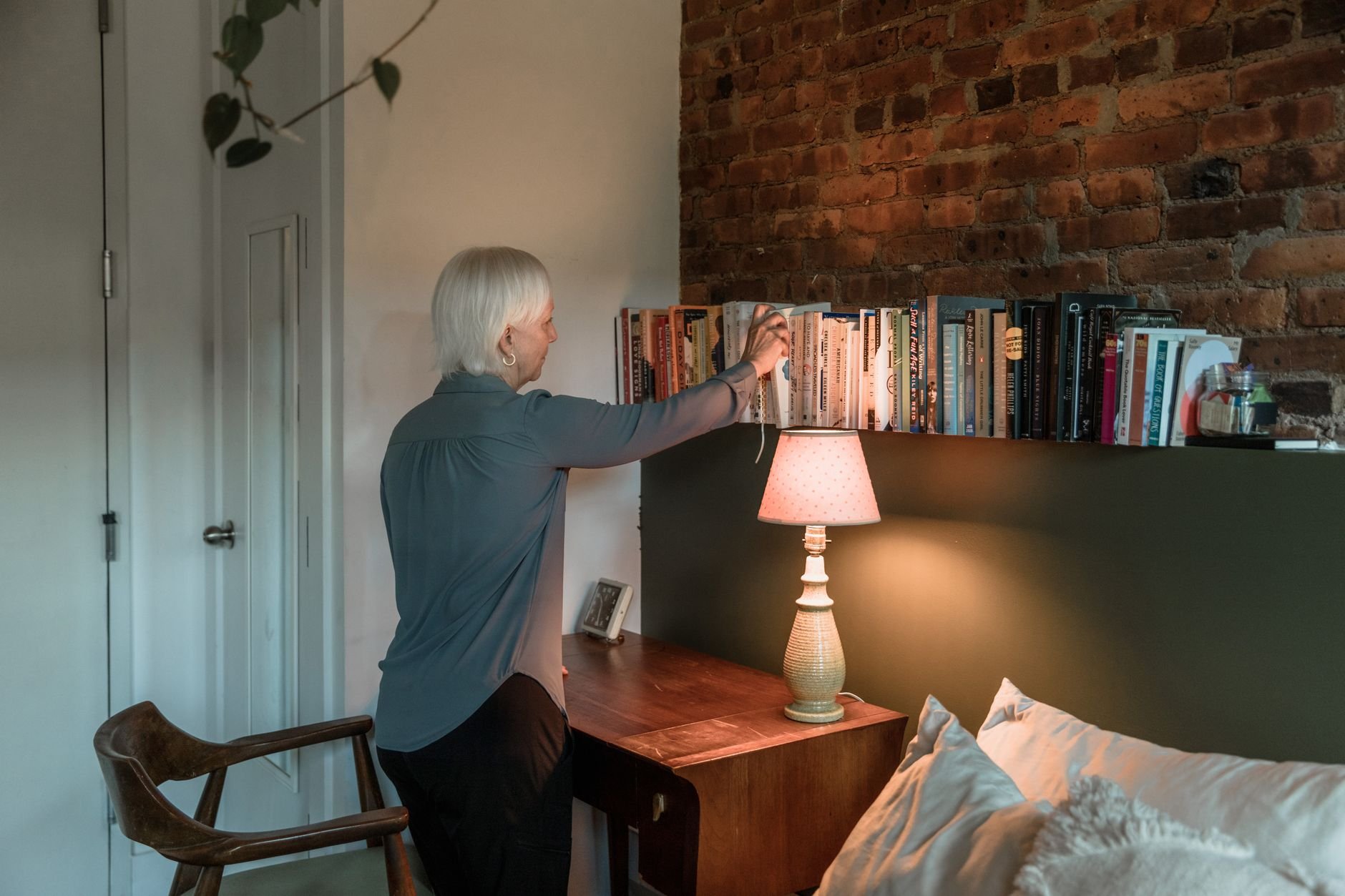 Warm cosy room with bookshelves and a lamp — a therapist's consulting room